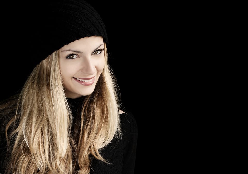 white blonde girl wearing a black bonnet